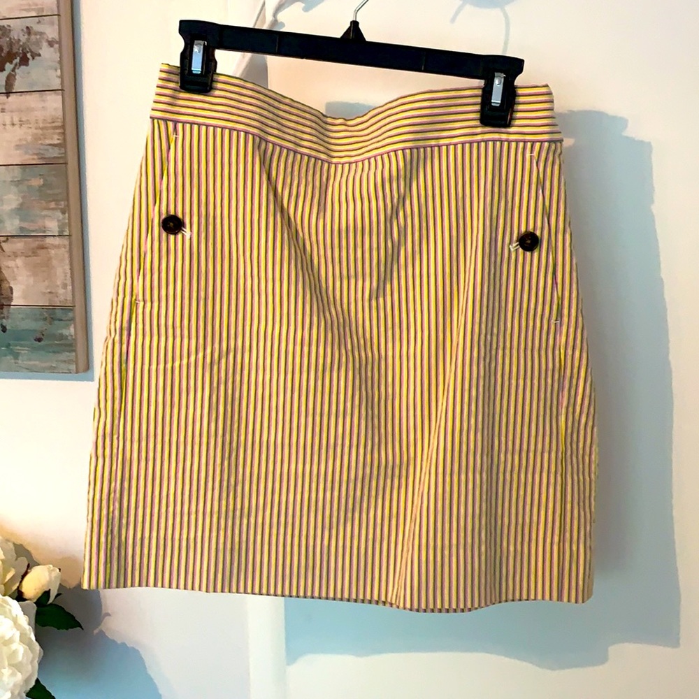 White, yellow,pink, and green striped skirt.